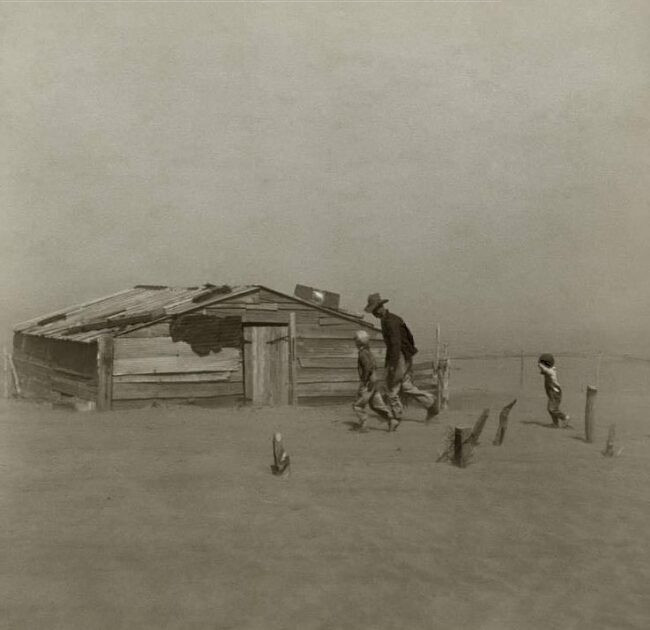 A farmer and his sons strolling through a dust storm. The Oklahoma county of Cimarron. 1936 April. Image courtesy of Arthur Rothstein.
