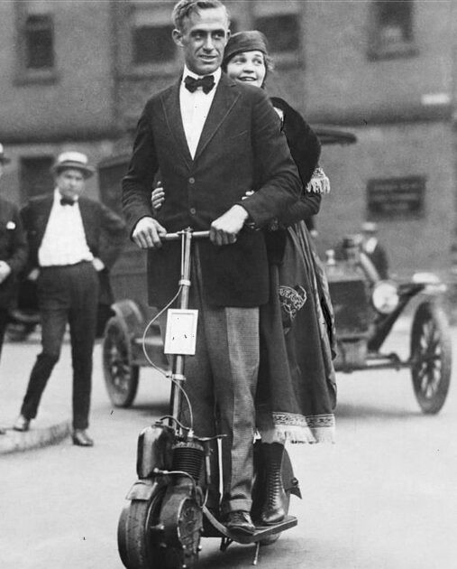 A couple riding on an autoped. The autoped, an early powered scooter, was designed in 1915. New York City, United States. Ca. 1923.
