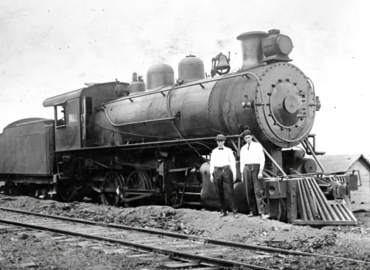 Kingsport locomotive near the south end of track 3. Two men are positioned close to the engine.