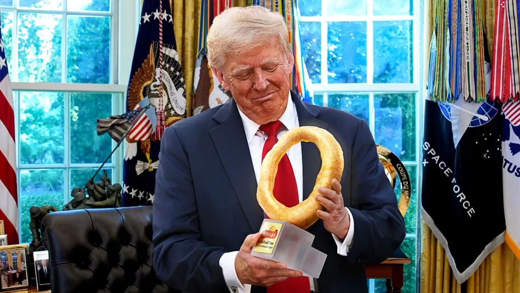 Frito-Lay CEO presenting Trump with a gold Funyun as a satirical bribe, per Washington, D.C. political stunt reports.